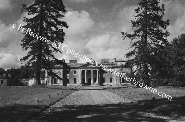 FRONTAL VIEW OF HOUSE WITH CLOUDS FROM AVENUE